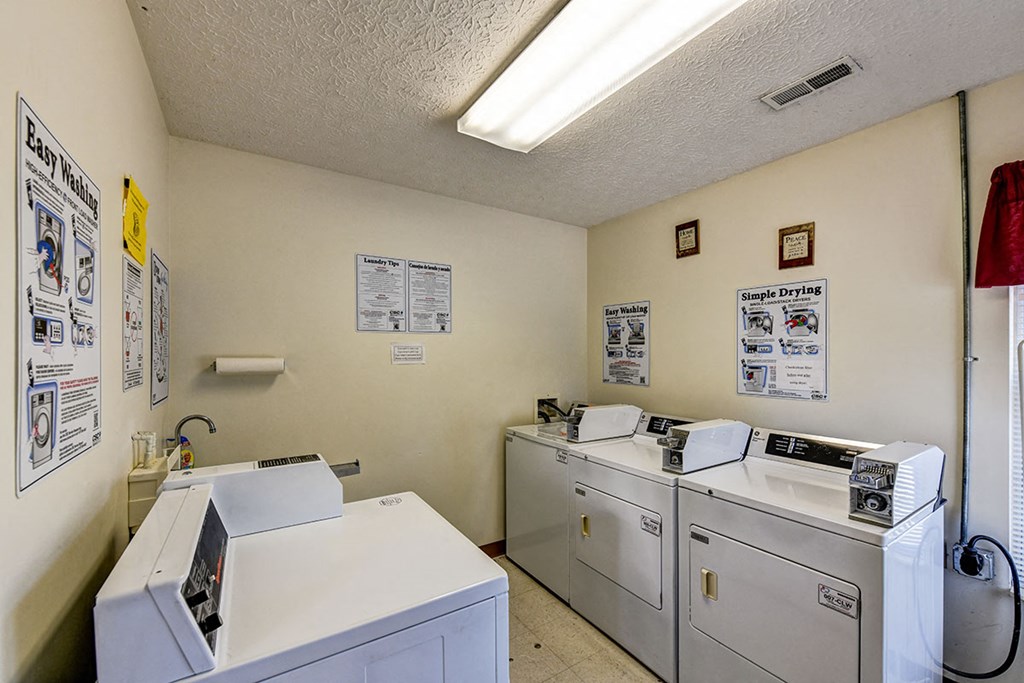 a laundry room with washes and dryers in it