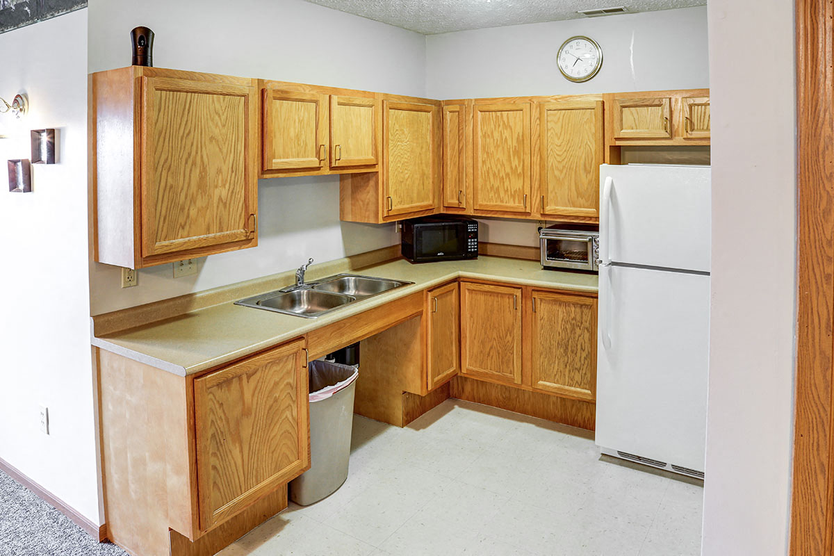 a kitchen with wooden cabinets and a white refrigerator