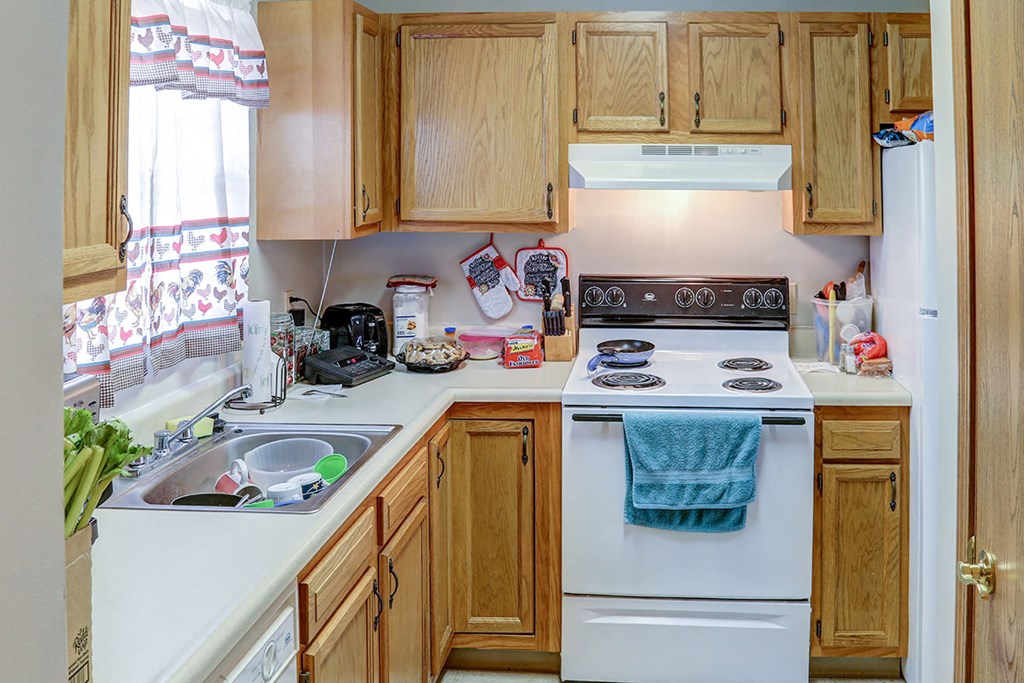 a kitchen with a stove top oven and a sink