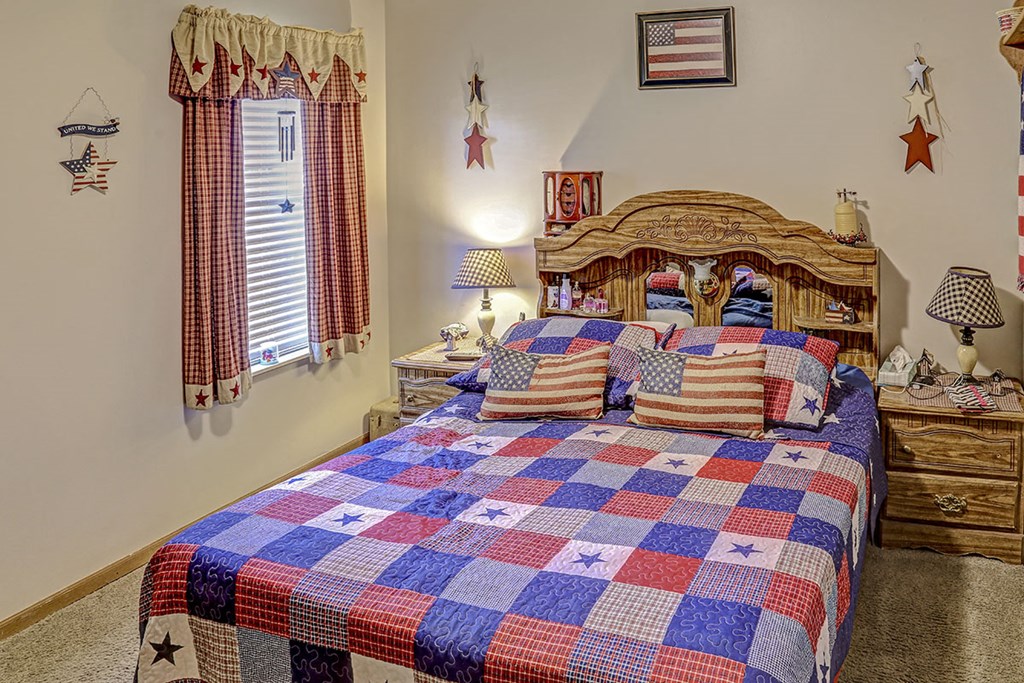 a bedroom with a bed with a checkered quilt