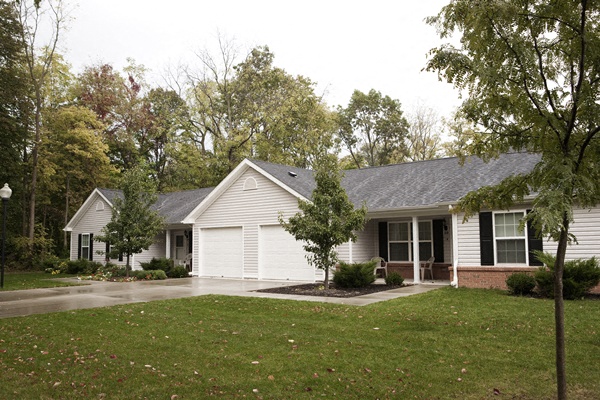 a white house with a yard and trees