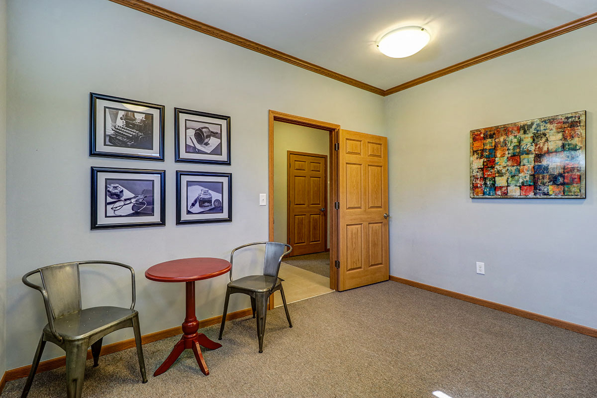 a living room with chairs and a table