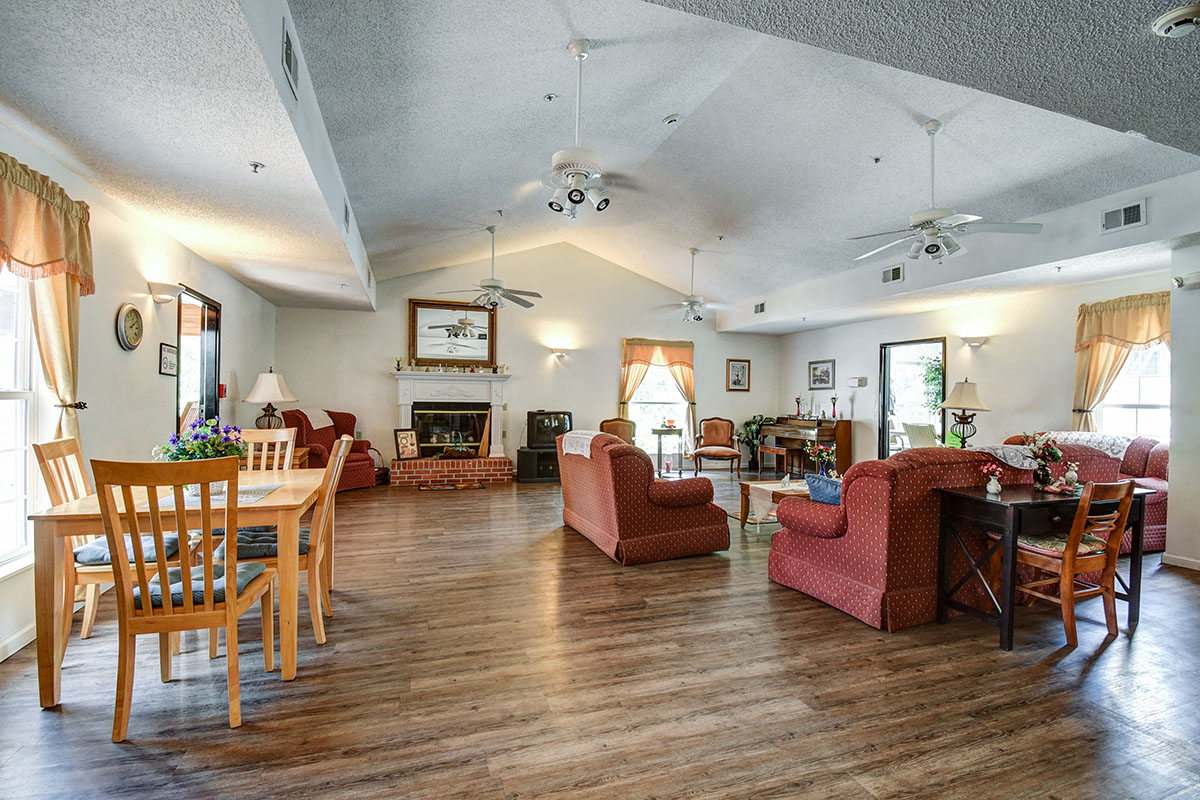 a living room and dining room with chairs and a table