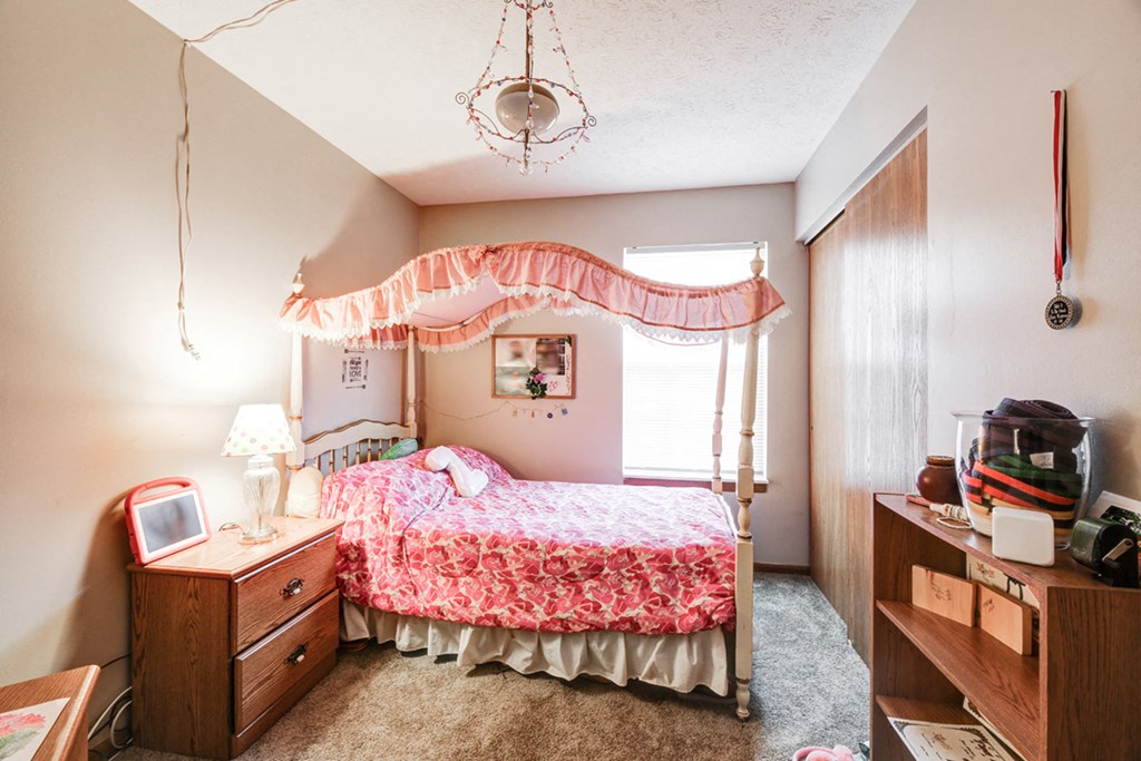 a bedroom with a bed and a dresser
