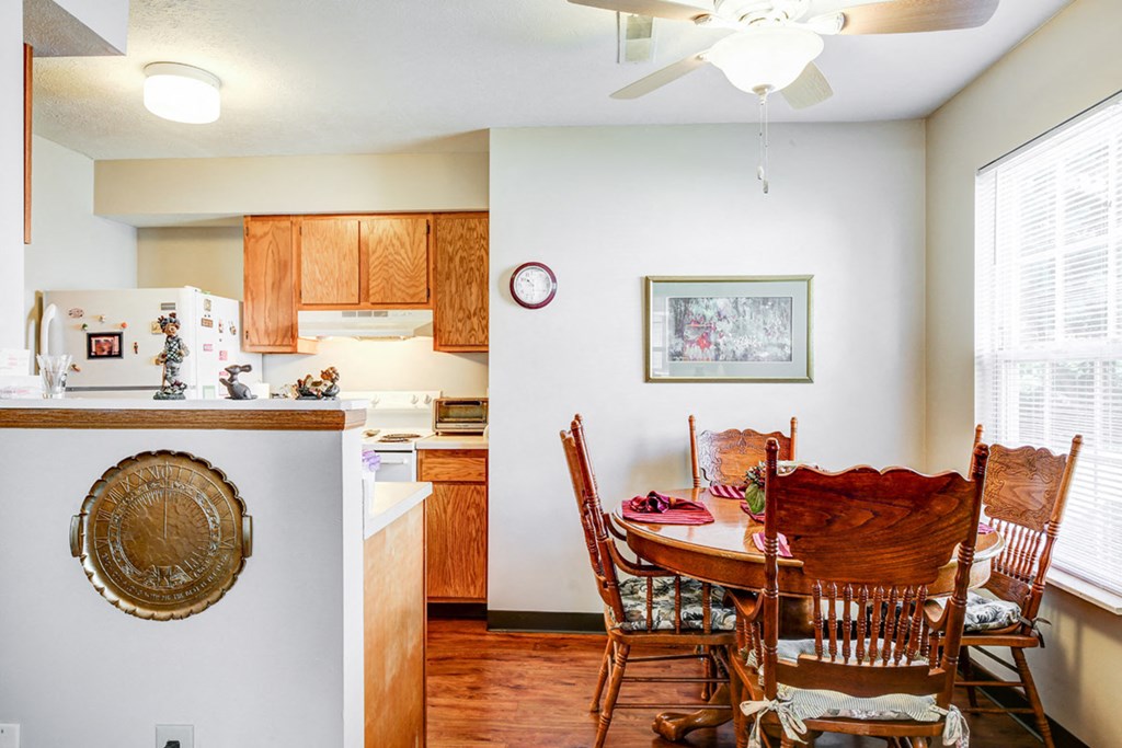 a kitchen and dining room with a table and chairs
