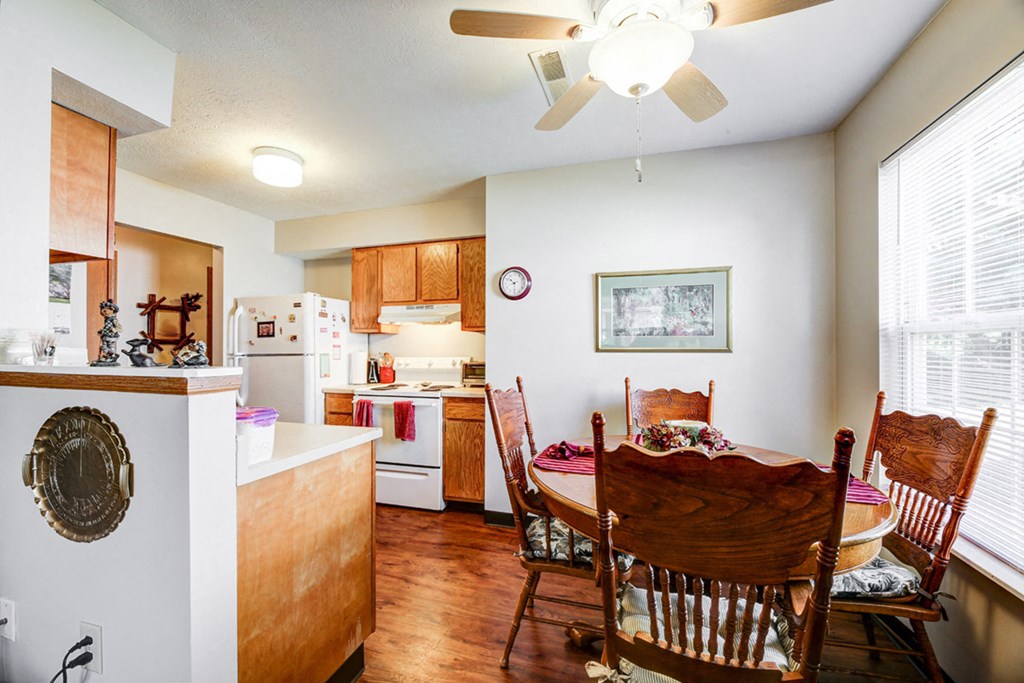 a kitchen and dining room with a table and chairs