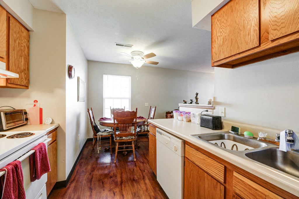 a kitchen and dining room with a table and chairs