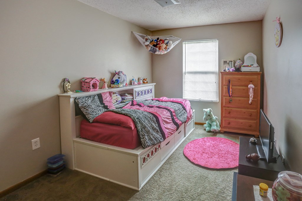 a bedroom with a bed and a dresser