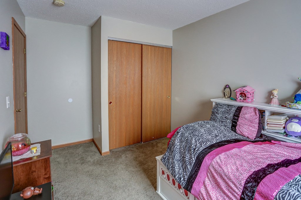 a bedroom with a bed and a closet