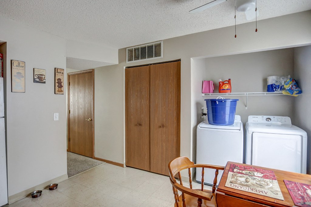 a kitchen with a dining table and a refrigerator