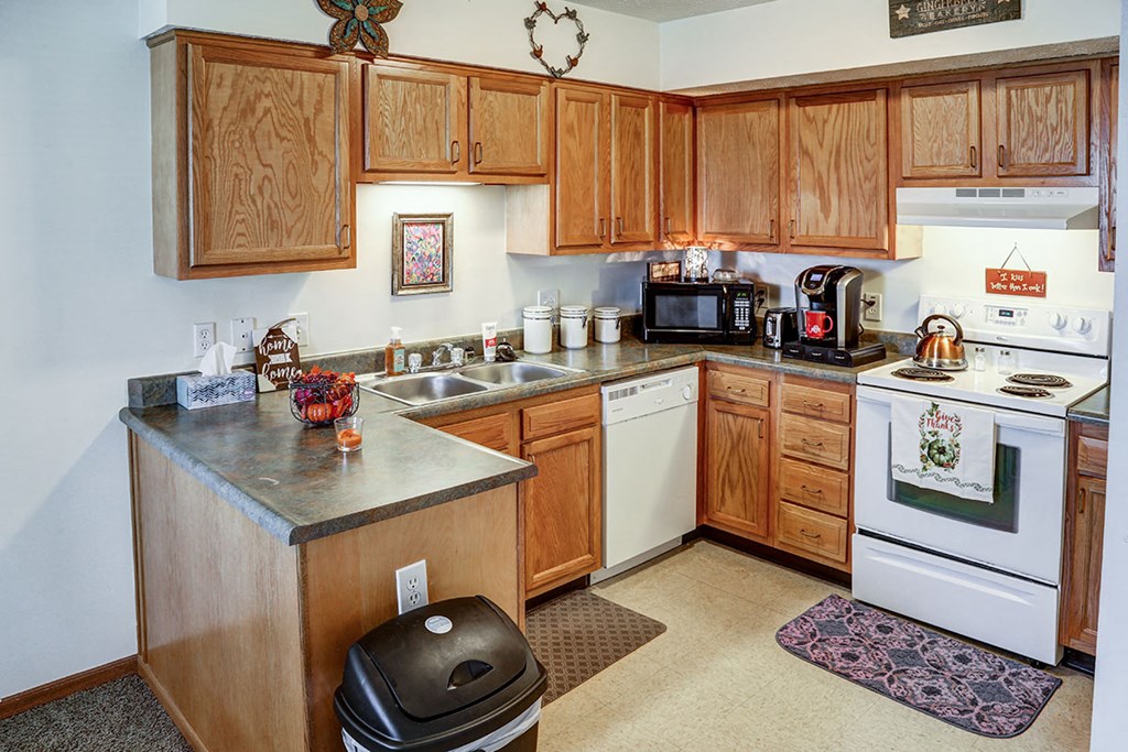 a kitchen with wooden cabinets and white appliances