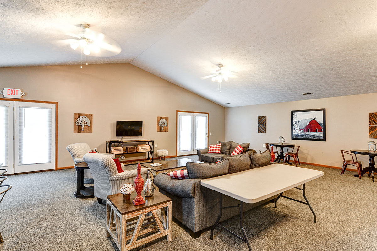 a living room with couches and chairs and a table