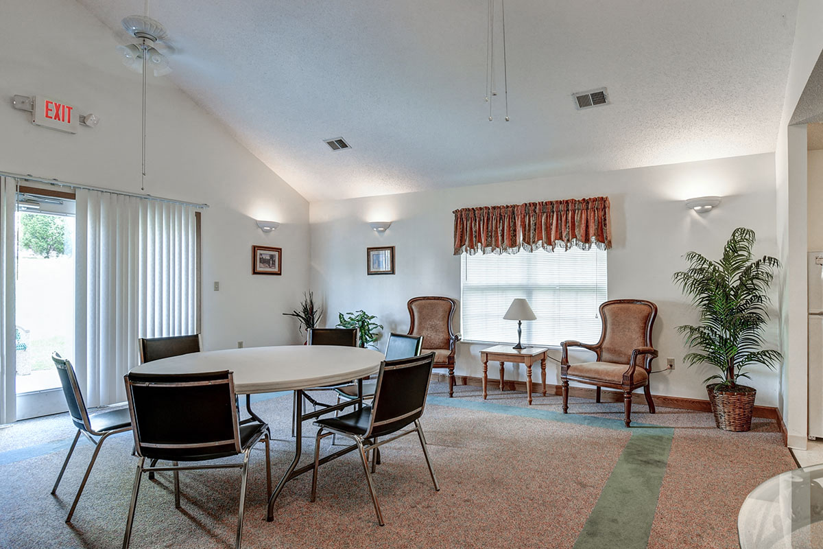 a dining room with a table and chairs and a living room