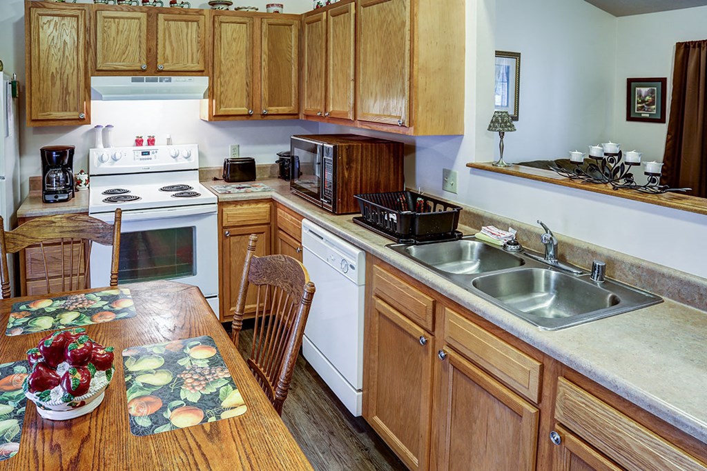 a kitchen with a wooden table and a sink