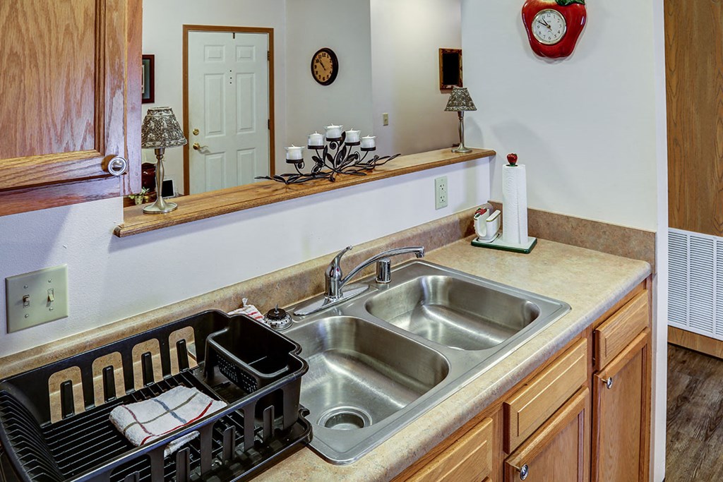 a kitchen with a stainless steel sink and a counter top