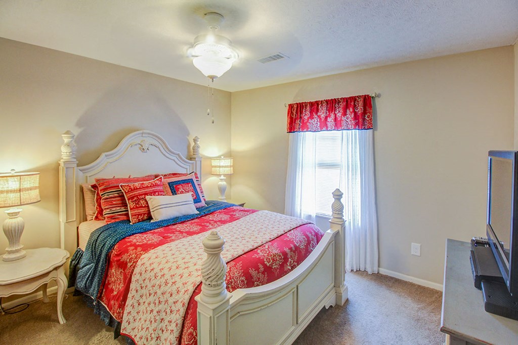 a bedroom with a bed and a window