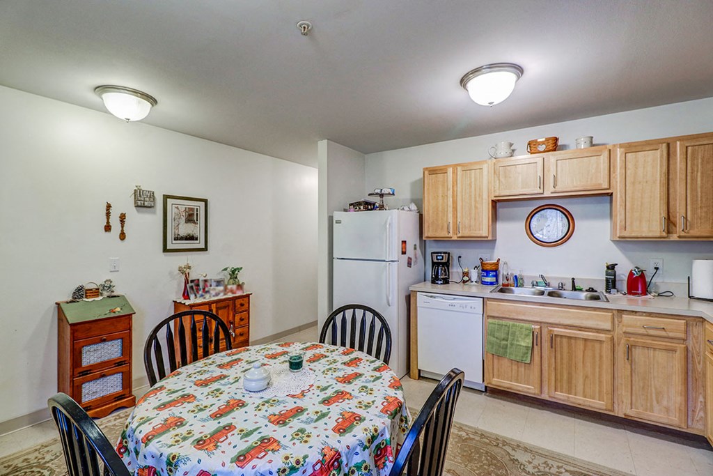 a kitchen and dining room with a table and chairs