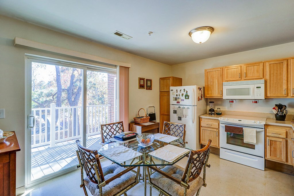a kitchen with a table and chairs