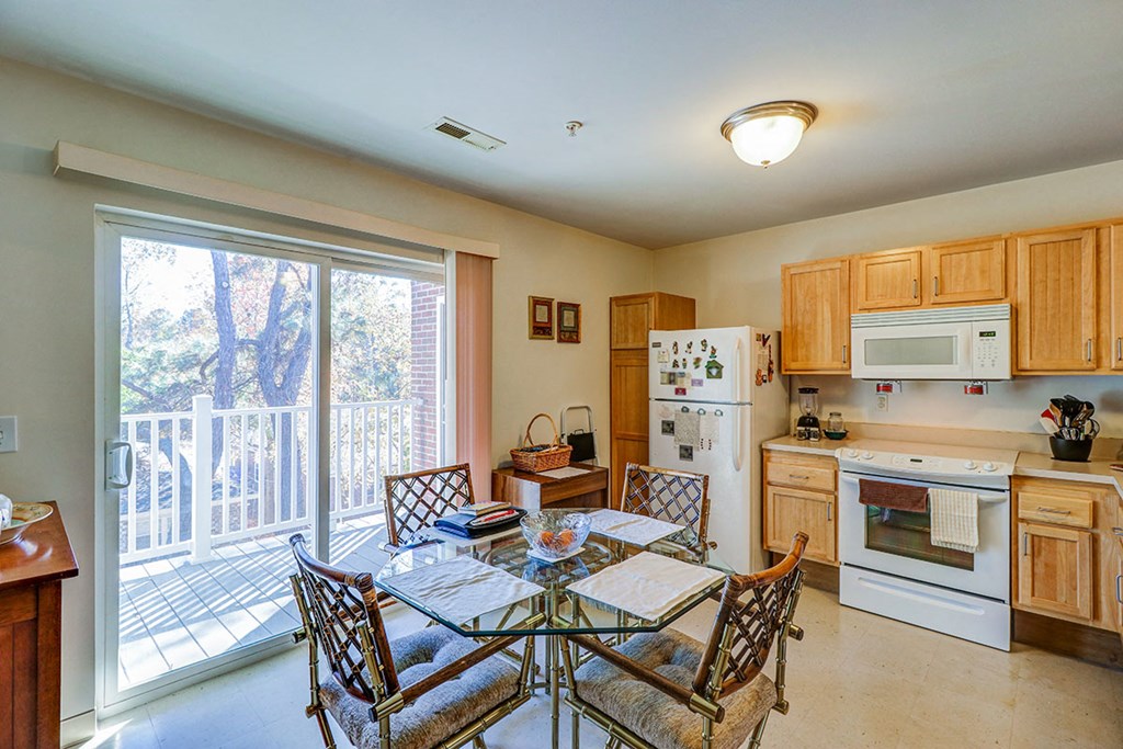 a kitchen with a table and chairs