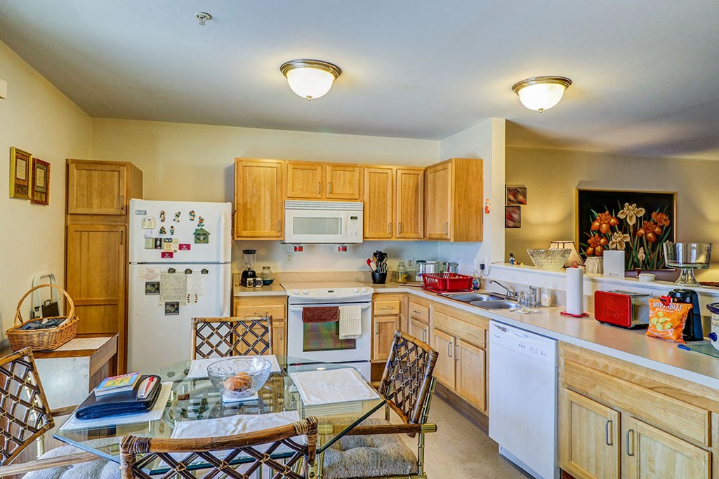 a kitchen with a table and chairs