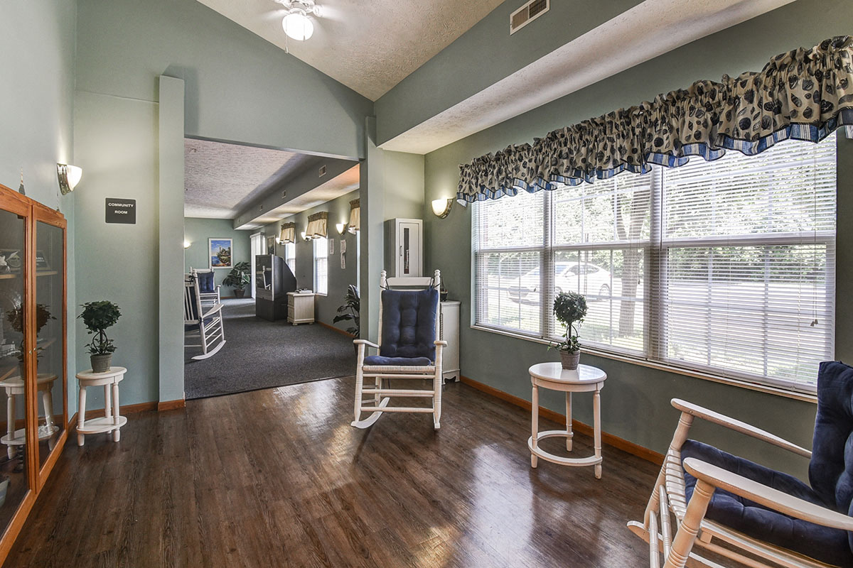 a living room with chairs and a large window