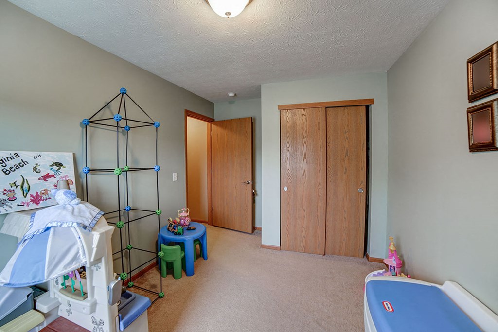 a nursery with a baby crib and a pool table