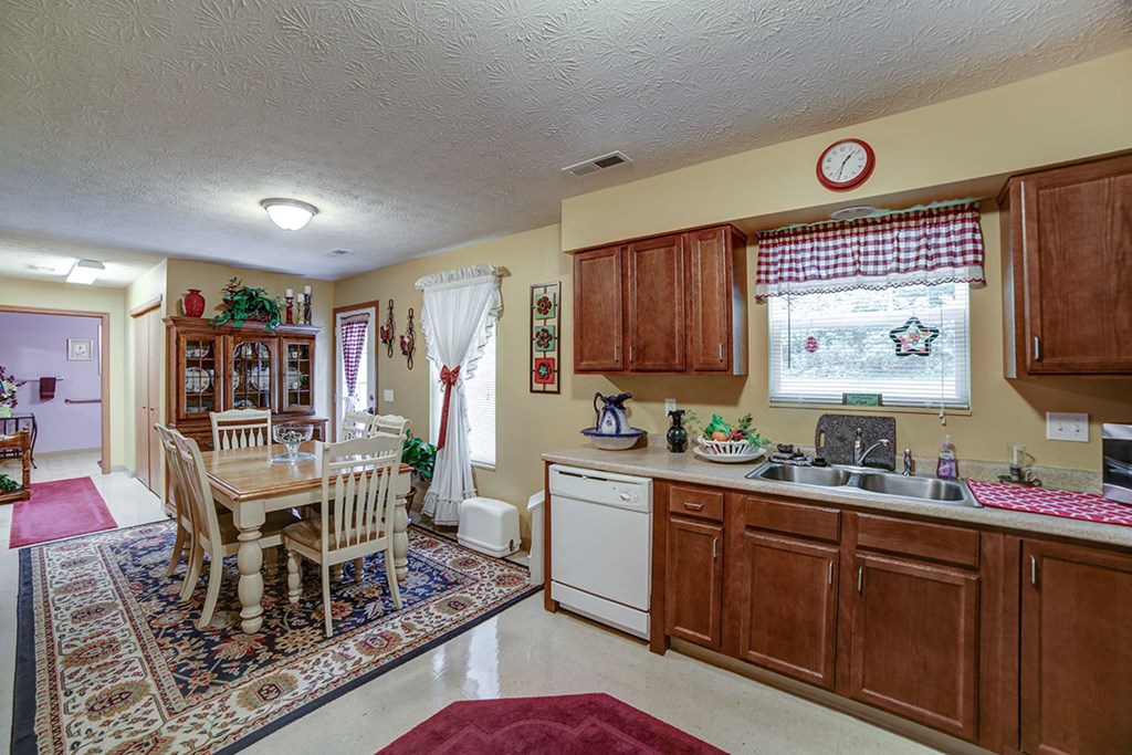 a kitchen with a dining table and a sink