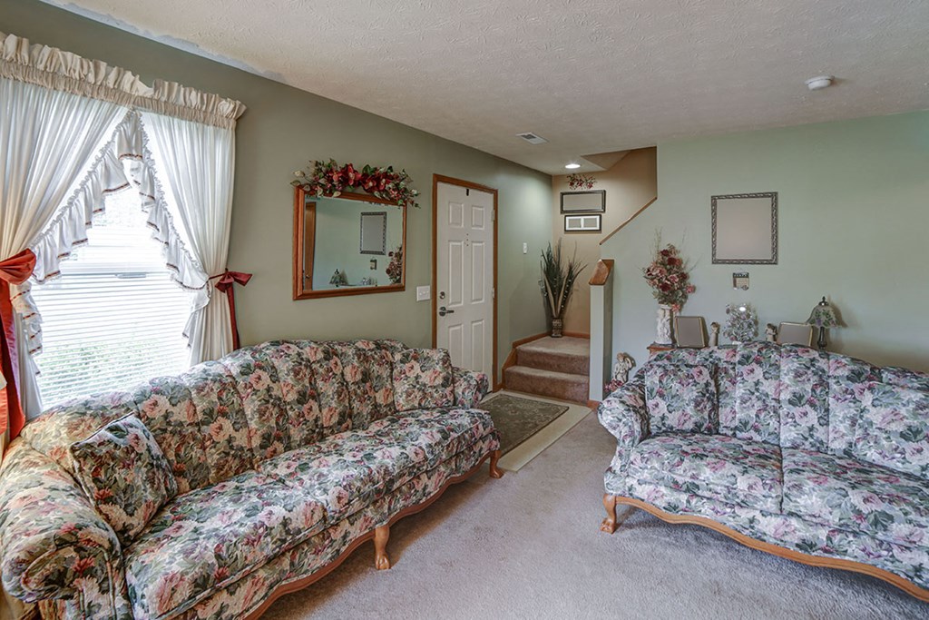 a living room with couches and a window