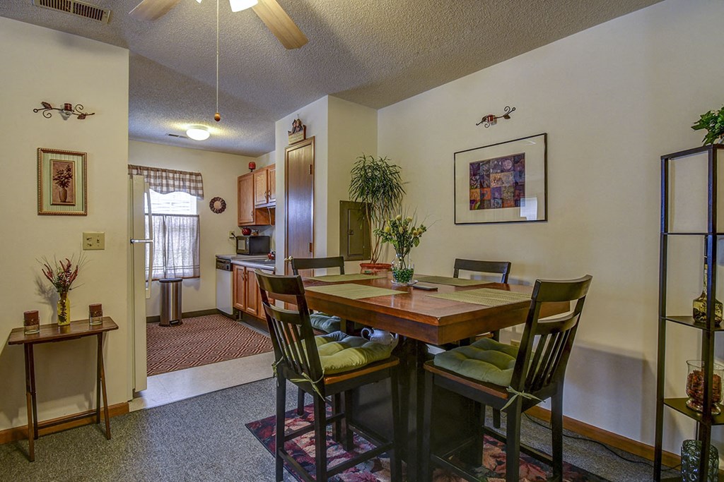 a dining area with a table and chairs in a living room