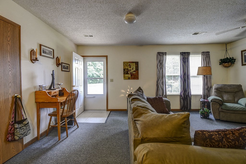 a living room and dining room with a couch and a table