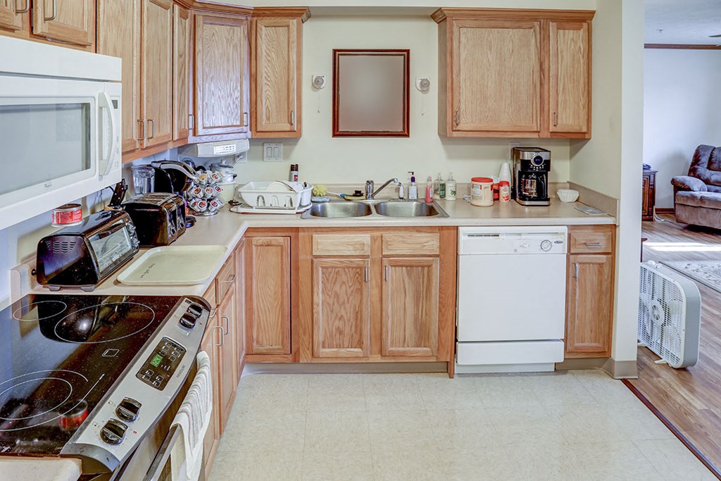 a kitchen with a stove microwave and sink