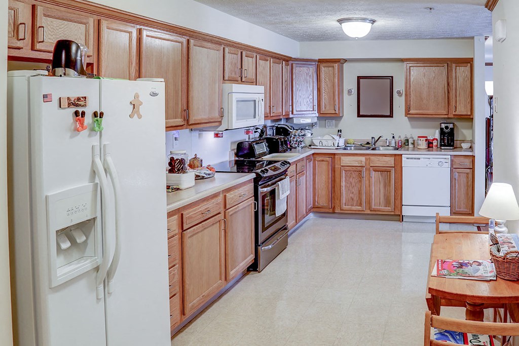 a kitchen with wooden cabinets and a white refrigerator