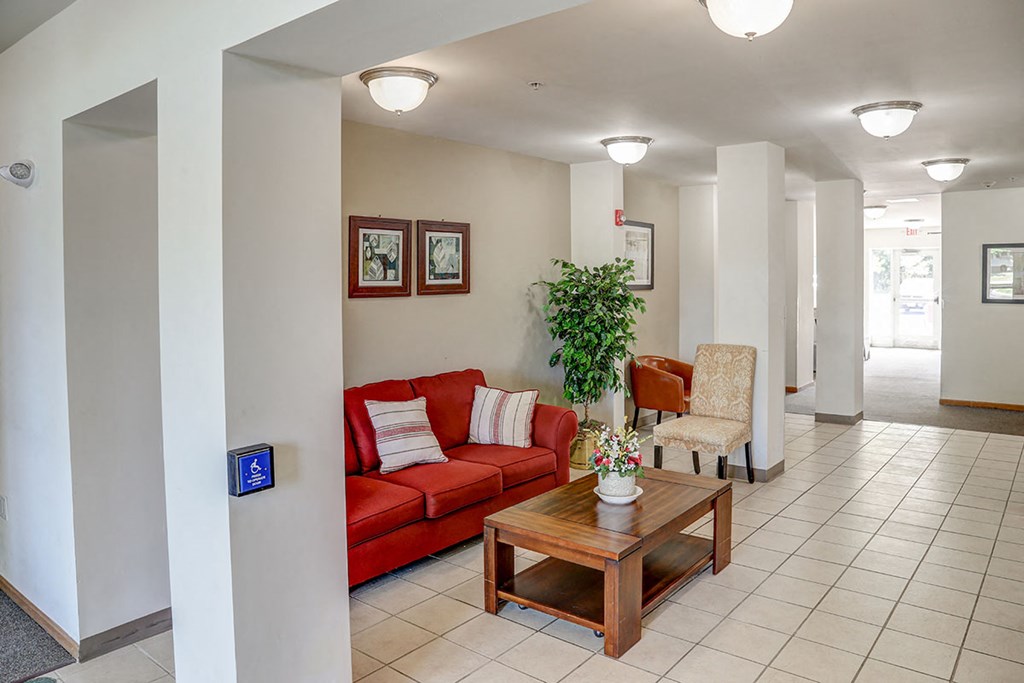 a living room with a red couch and a table