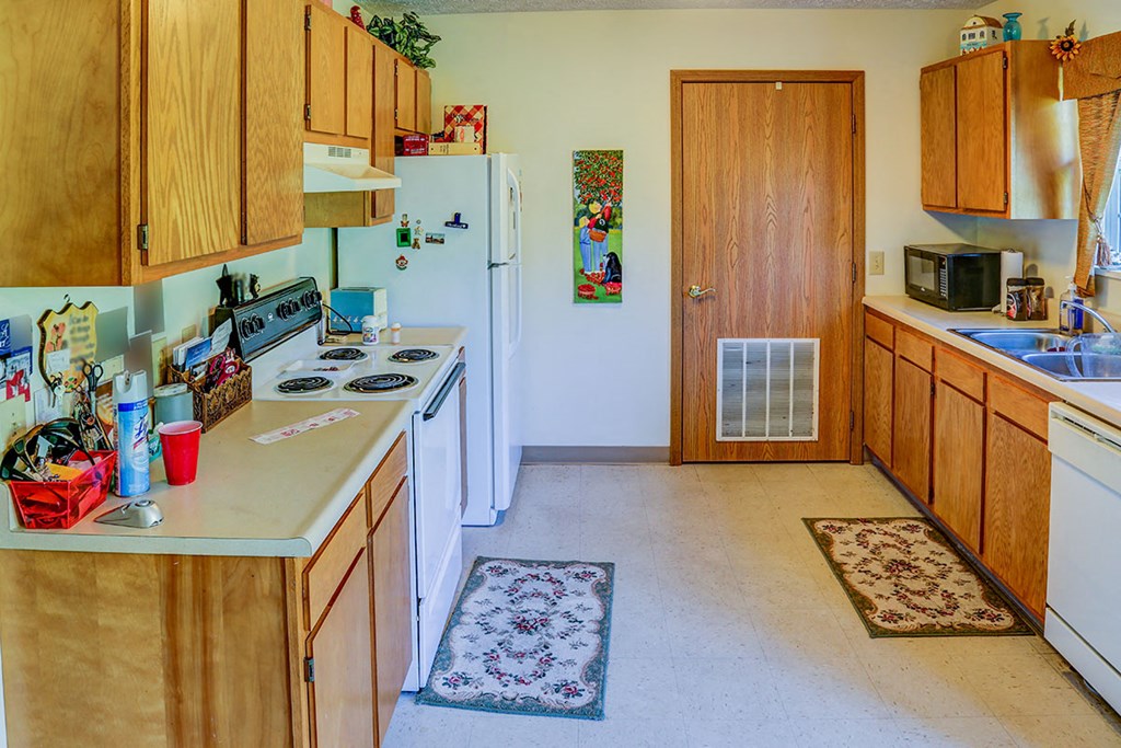 a kitchen with a stove refrigerator and a sink