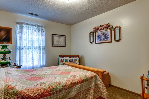 a bedroom with a bed and a window