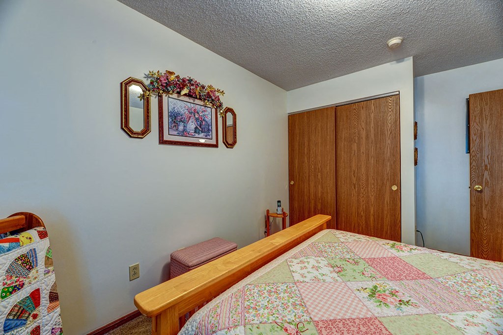 a bedroom with a bed with a quilt in it