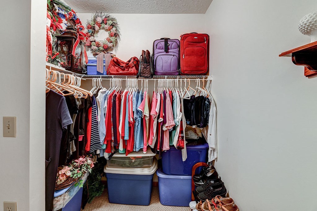 a closet filled with clothes and in it