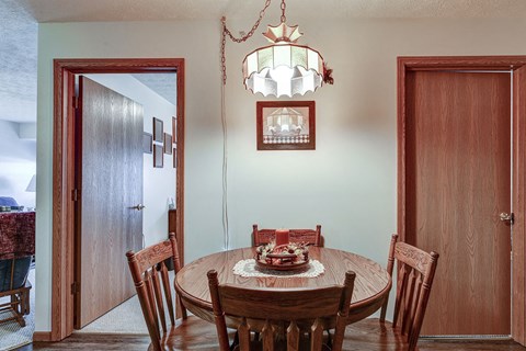 a dining room with a table and chairs and a chandelier