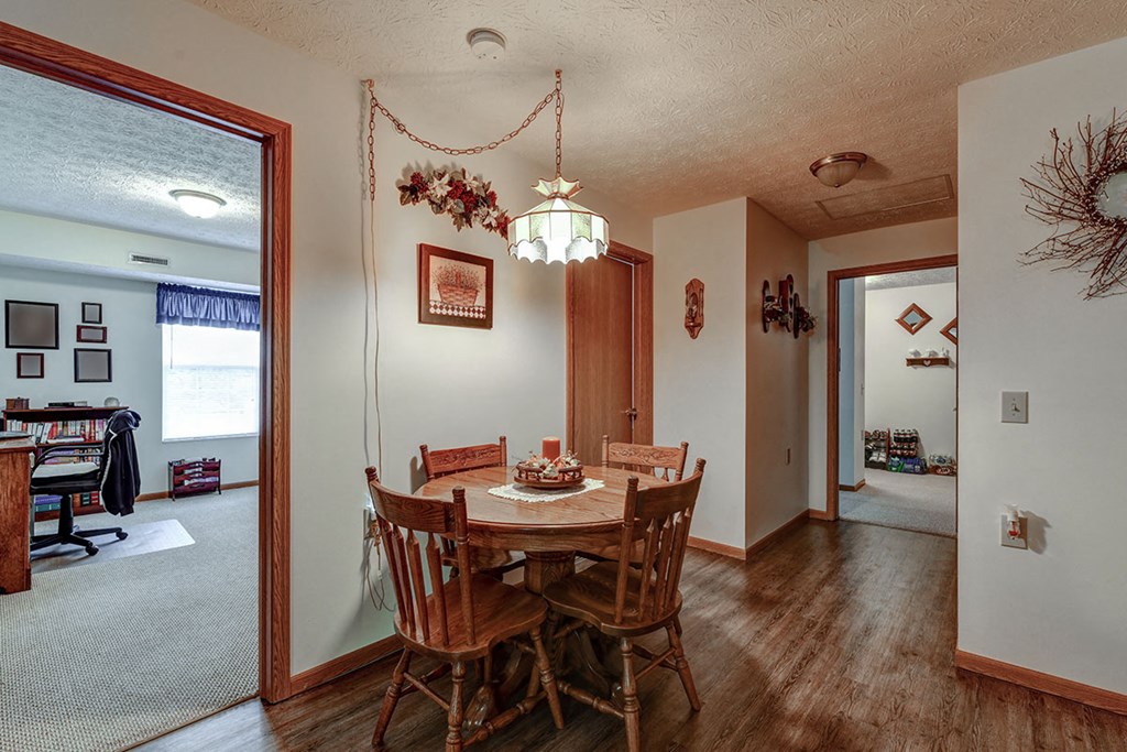 a dining room with a table and chairs and a living room