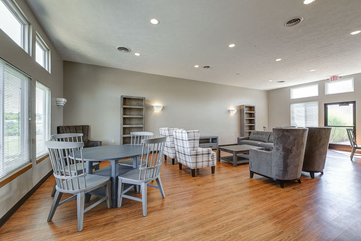 a living room with a table and chairs and a couch
