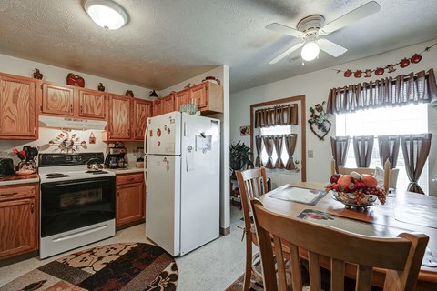 a kitchen with a dining table and a refrigerator