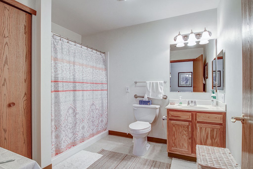 a bathroom with a toilet and a sink and a shower