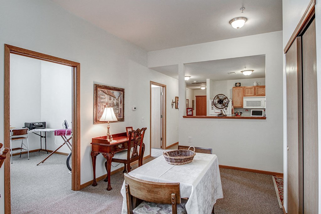 a living room with a dining room table and a kitchen