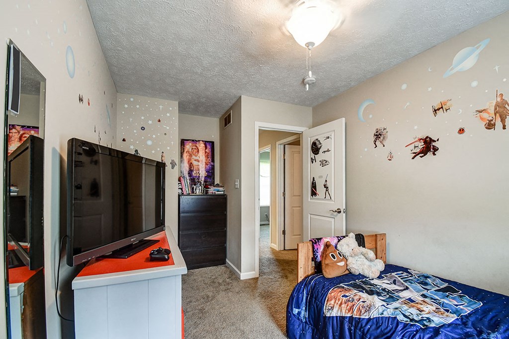 a bedroom with a bed and a tv