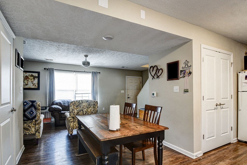 a dining room and living room with a table and chairs