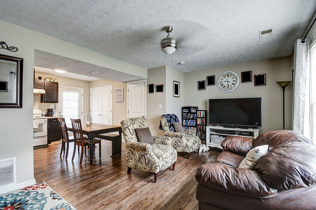 a living room with a leather couch and a tv