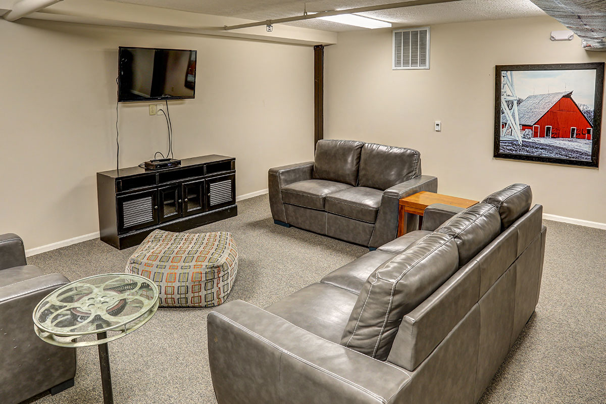 a living room with leather couches and a television