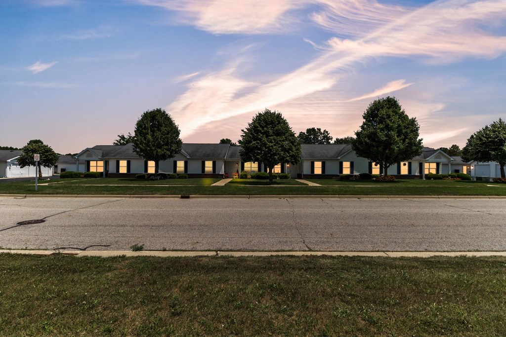 a house on the side of a road at sunset