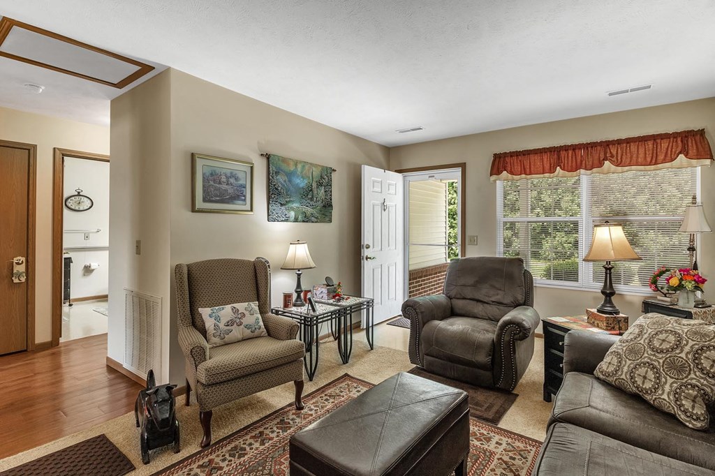 a living room with furniture and a door to a bathroom