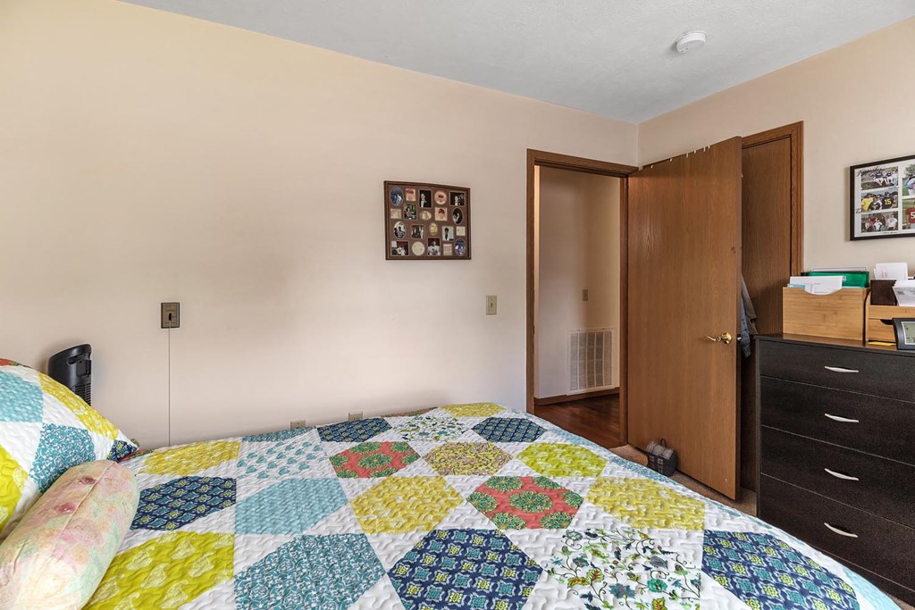 a bedroom with a bed and a quilt